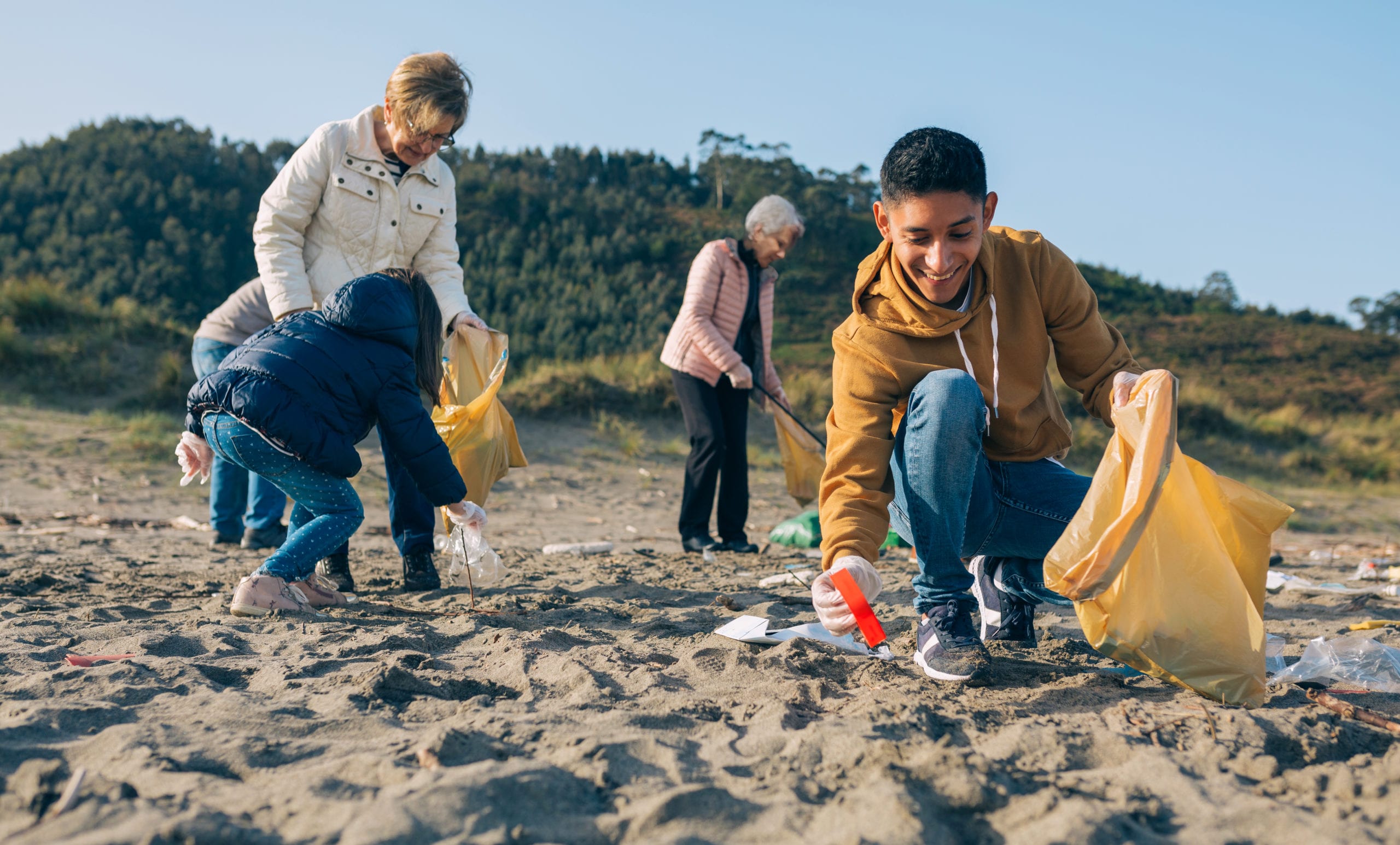 Young man cleaning the beach